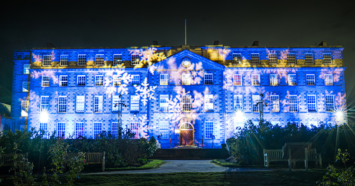Ushaw historic house illuminated for Christmas in blue and snowflakes